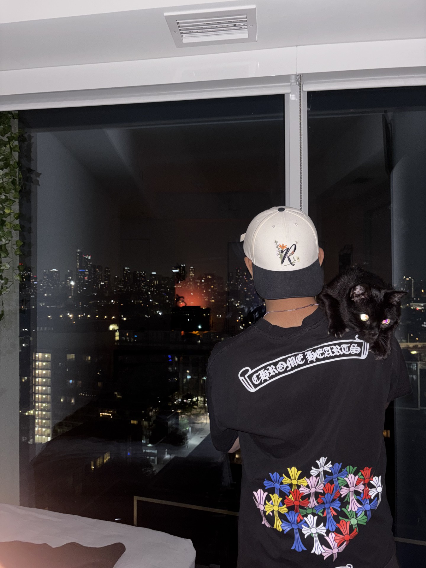 Tony wearing Chrome Hearts overlooking the Toronto skyline at night